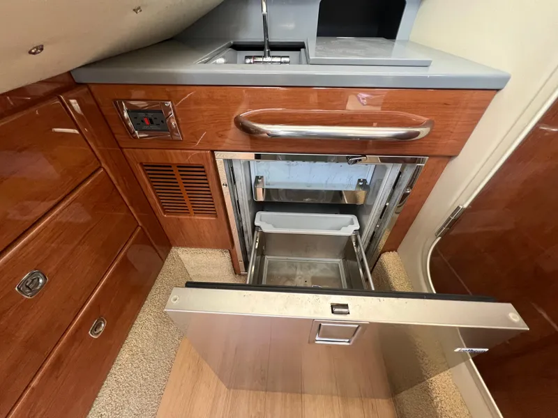 Slide: The Image of 2014 Formula 350 Crossover Bowrider interior kitchen with open drawer and sink. - 46