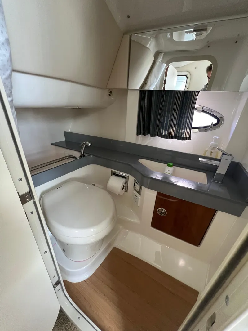 Slide: The Image of 2014 Formula 350 Crossover Bowrider bathroom with modern fixtures and wooden flooring. - 48