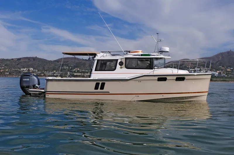 The Image of 2024 Ranger Tugs R-27 boat on calm water with scenic background. - 1