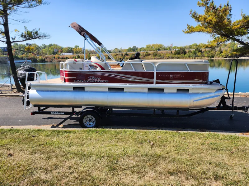 Slide: The Image of 2012 Sun Tracker Party Barge 20 DLX pontoon boat on trailer by a lake. - 10