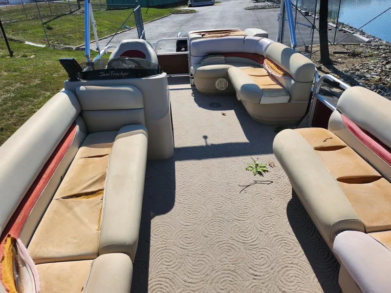 Slide: The Image of 2012 Sun Tracker Party Barge 20 DLX interior with beige seating and carpet. - 11