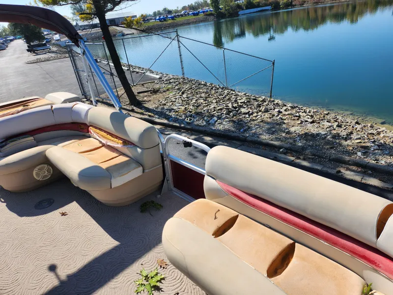 Slide: The Image of 2012 Sun Tracker Party Barge 20 DLX pontoon boat interior by a lakeside. - 12