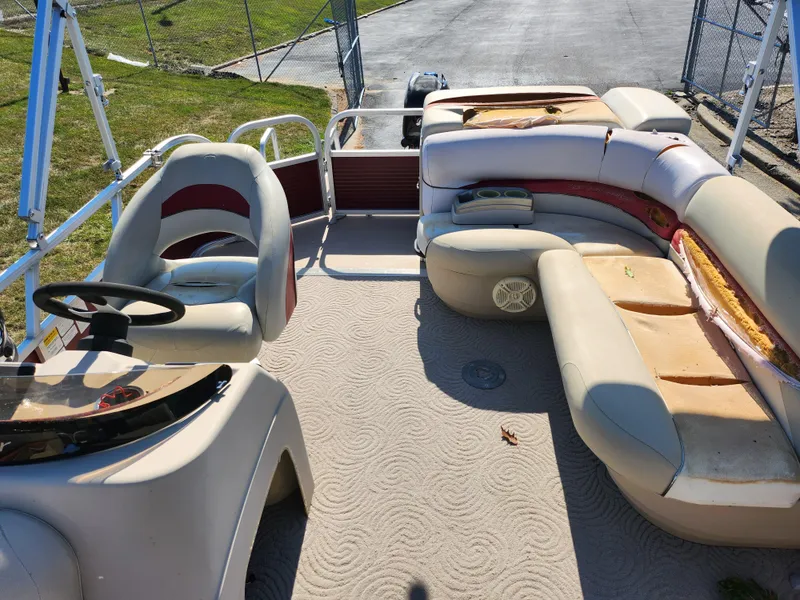 Slide: The Image of 2012 Sun Tracker Party Barge 20 DLX interior with seating and steering console. - 13