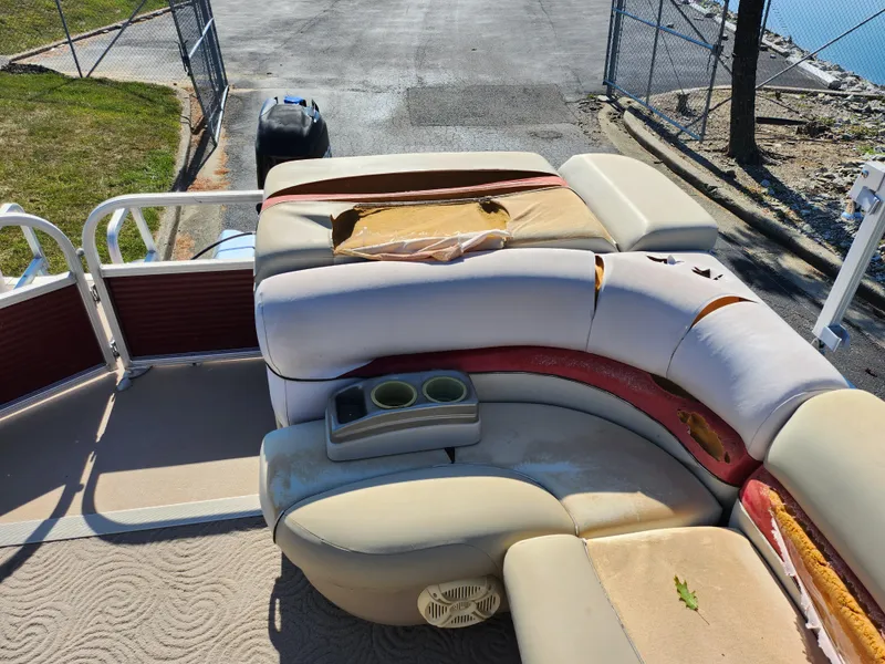 Slide: The Image of 2012 Sun Tracker Party Barge 20 DLX with worn seating and cup holders. - 15