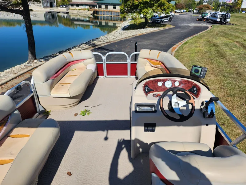 Slide: The Image of 2012 Sun Tracker Party Barge 20 DLX pontoon boat interior with seating and steering console. - 19