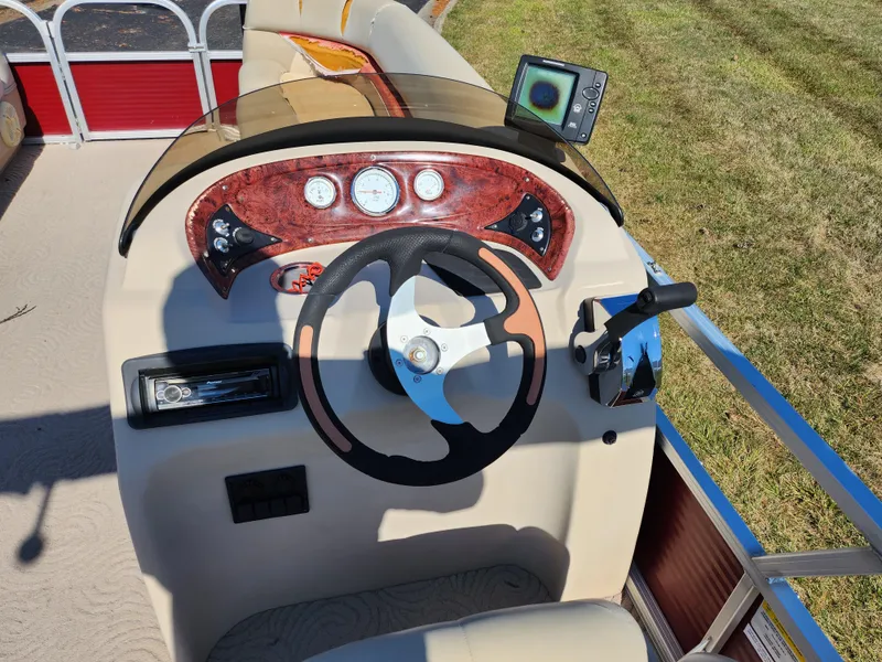 Slide: The Image of 2012 Sun Tracker Party Barge 20 DLX steering console with gauges and GPS. - 20