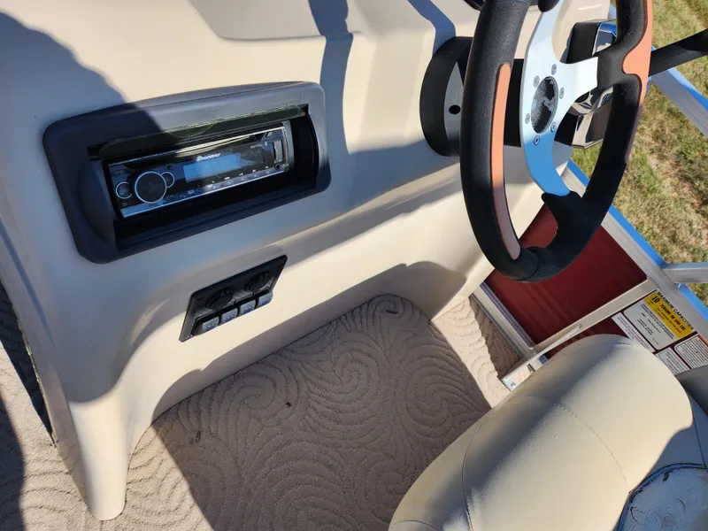 Slide: The Image of 2012 Sun Tracker Party Barge 20 DLX steering console with stereo system and controls. - 21