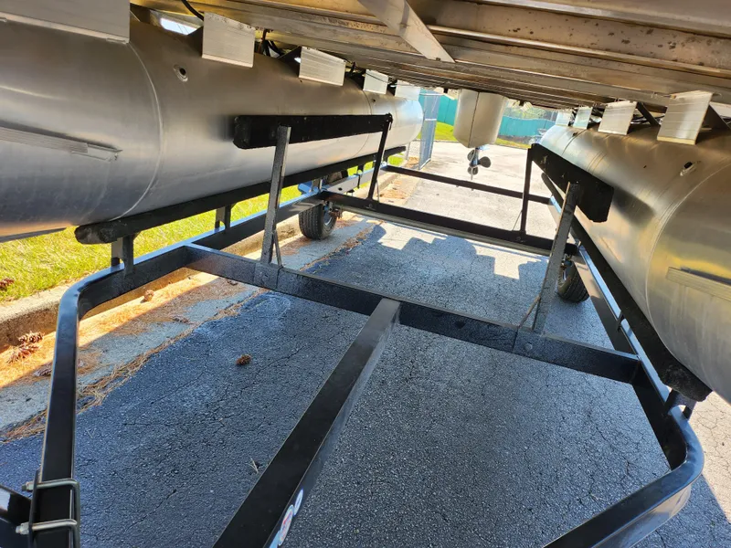 Slide: The Image of Underneath view of a 2012 Sun Tracker Party Barge 20 DLX pontoon boat on a trailer. - 8