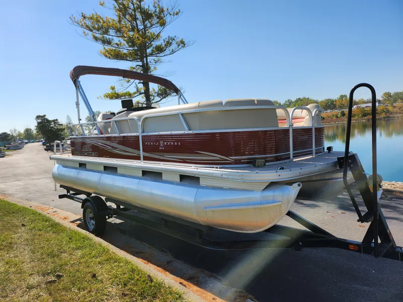 Slide: The Image of 2012 Sun Tracker Party Barge 20 DLX pontoon boat on trailer by a lake. - 9