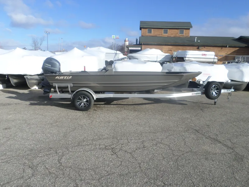 Slide: The Image of 2022 Alweld 1860 VV Marsh Console boat on trailer, parked outdoors. - 1