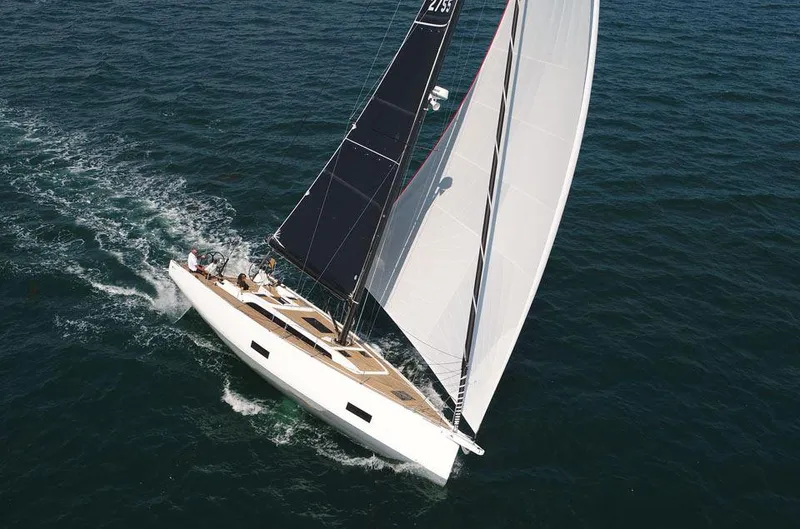 Slide: The Image of 2025 Solaris 44 yacht sailing on open sea with full sails. - 5