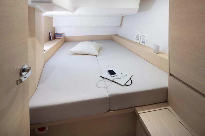 Slide: The Image of Cozy cabin interior of Solaris 44 yacht, featuring a neatly made bed and minimalistic decor. - 8