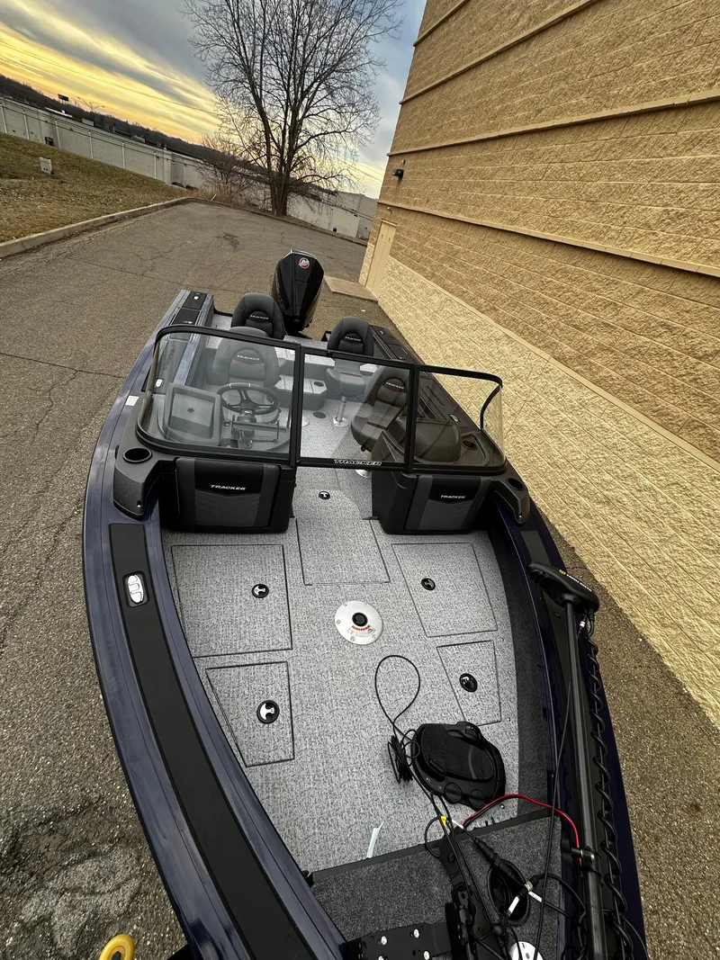 Slide: The Image of 2024 Tracker Targa V-19 WT boat parked beside a building at sunset. - 7