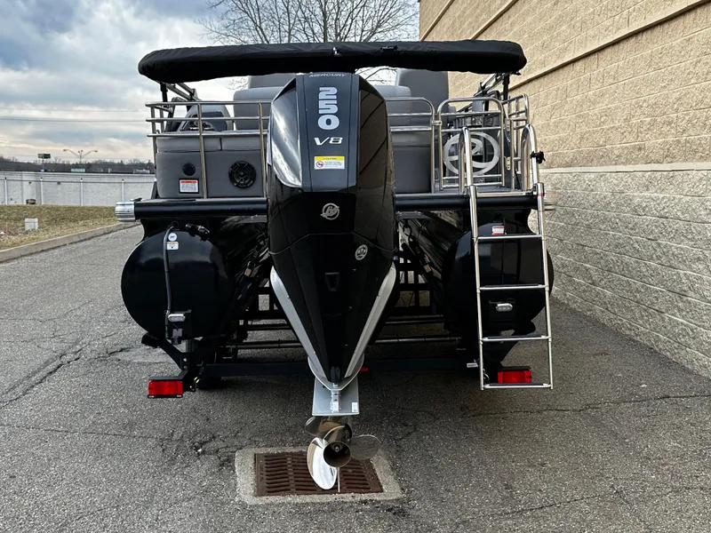 Slide: The Image of 2024 Regency 230 LE3 Sport pontoon boat with 250 V8 engine, rear view. - 2
