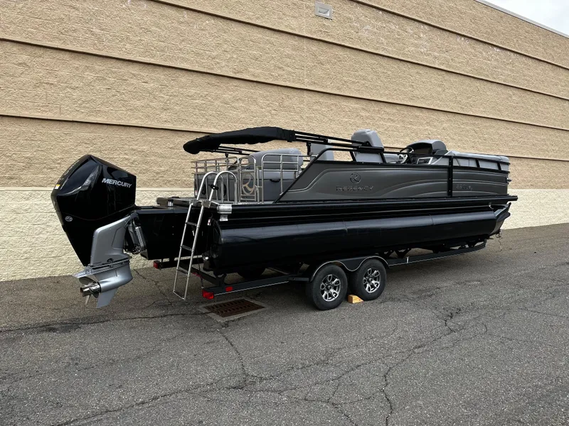 Slide: The Image of 2024 Regency 230 LE3 Sport pontoon boat on trailer, black exterior. - 8