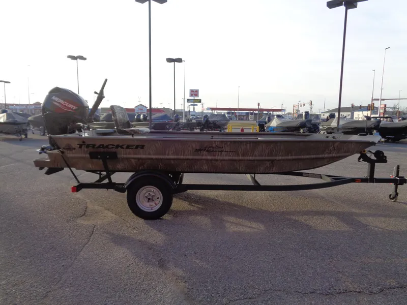 Slide: The Image of 2024 Tracker Grizzly 1654 T Sportsman boat on trailer in parking lot. - 3