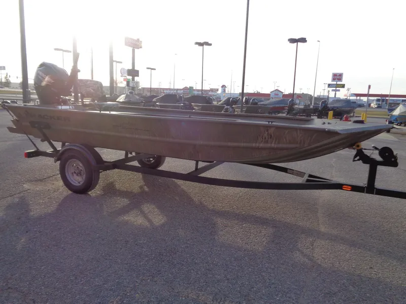 Slide: The Image of 2024 Tracker Grizzly 1654 T Sportsman boat on a trailer in a parking lot. - 5