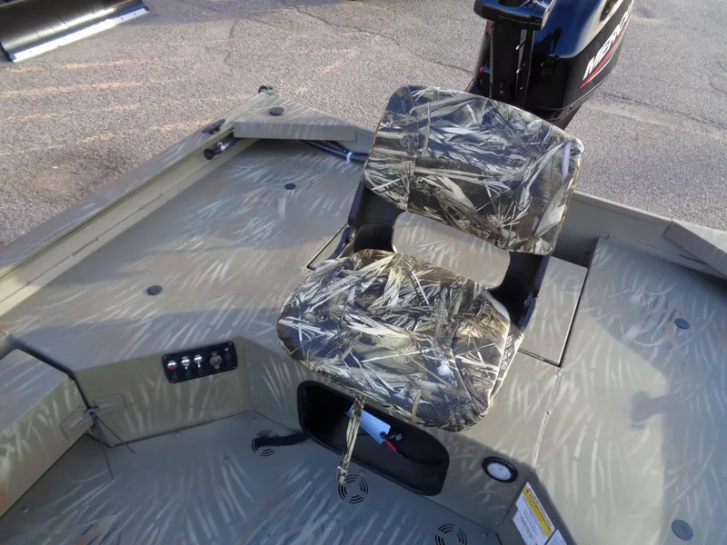 Slide: The Image of 2024 Tracker Grizzly 1654 T Sportsman boat with camo seat and control panel. - 8