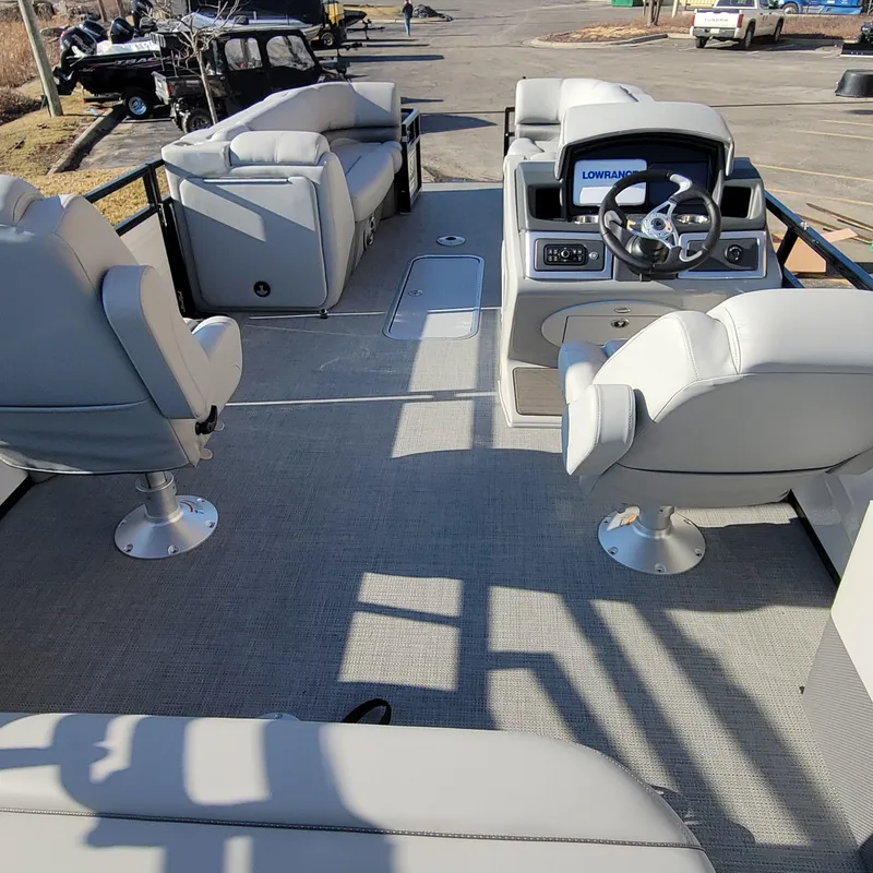 Slide: The Image of 2024 Regency 250 DL3 pontoon boat interior with plush seating and modern dashboard. - 3
