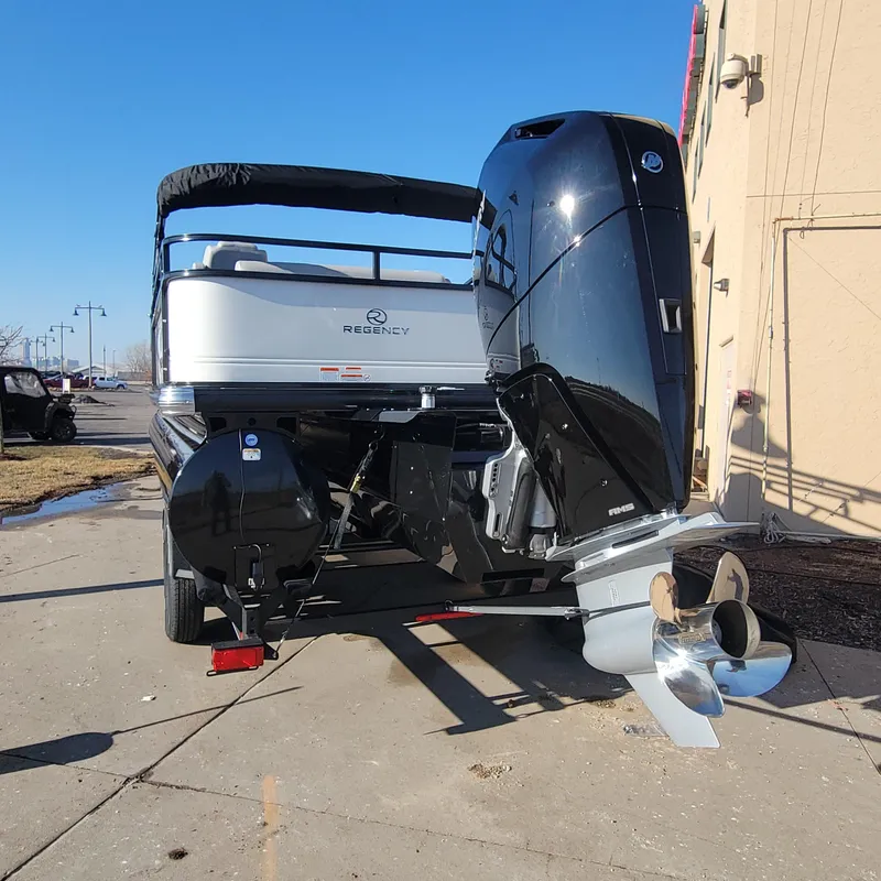 Slide: The Image of 2024 Regency 250 DL3 pontoon boat with powerful outboard motor. - 4