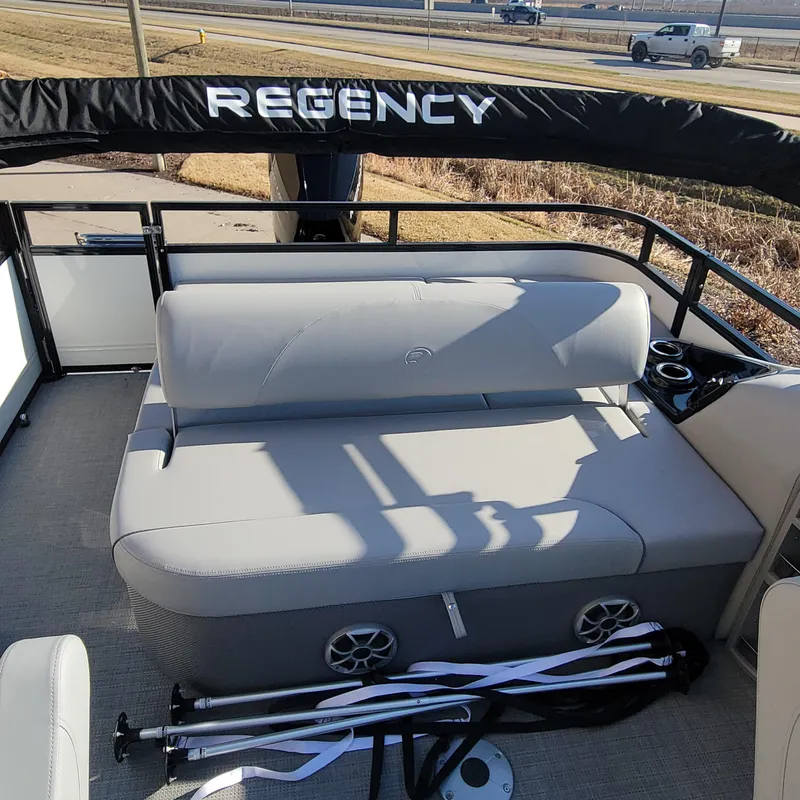 Slide: The Image of 2024 Regency 250 DL3 boat interior with cushioned seating and cup holders. - 5