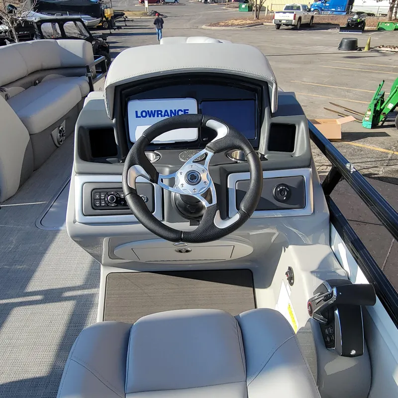 Slide: The Image of 2024 Regency 250 DL3 boat dashboard with Lowrance navigation system and steering wheel. - 6