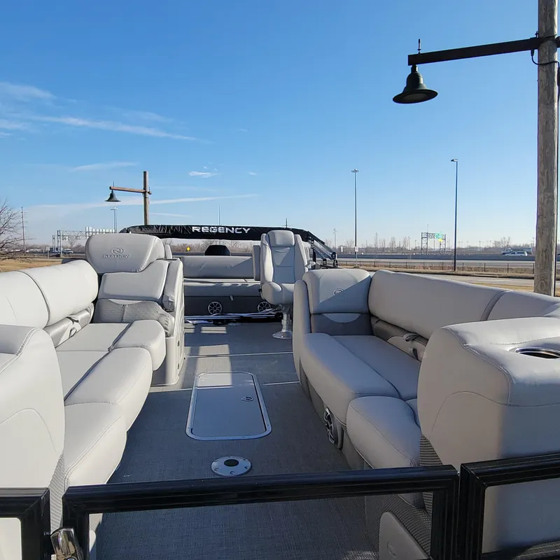 Slide: The Image of 2024 Regency 250 DL3 pontoon boat with luxurious seating and modern design. - 7