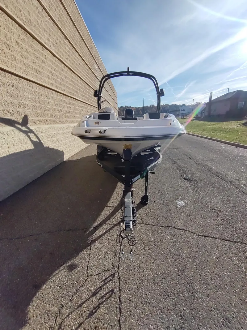 Slide: The Image of 2024 Tahoe 1950 boat on trailer, parked outdoors, sunny day. - 5