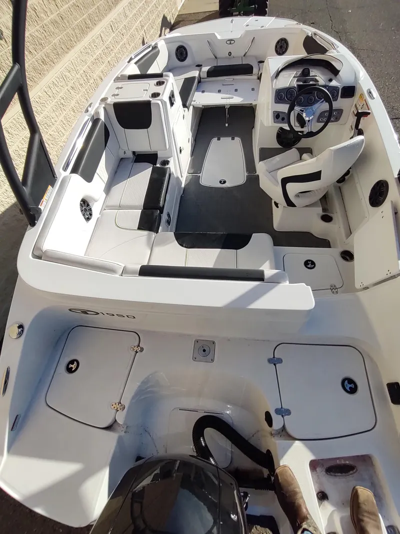 Slide: The Image of 2024 Tahoe 1950 boat interior with modern seating and steering console. - 6