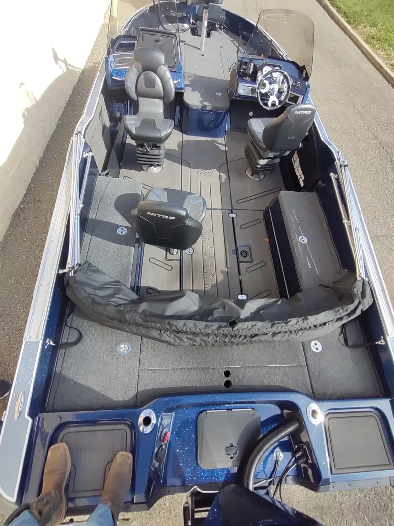Slide: The Image of 2024 Nitro ZV21 Pro fishing boat interior with seating and steering console. - 4
