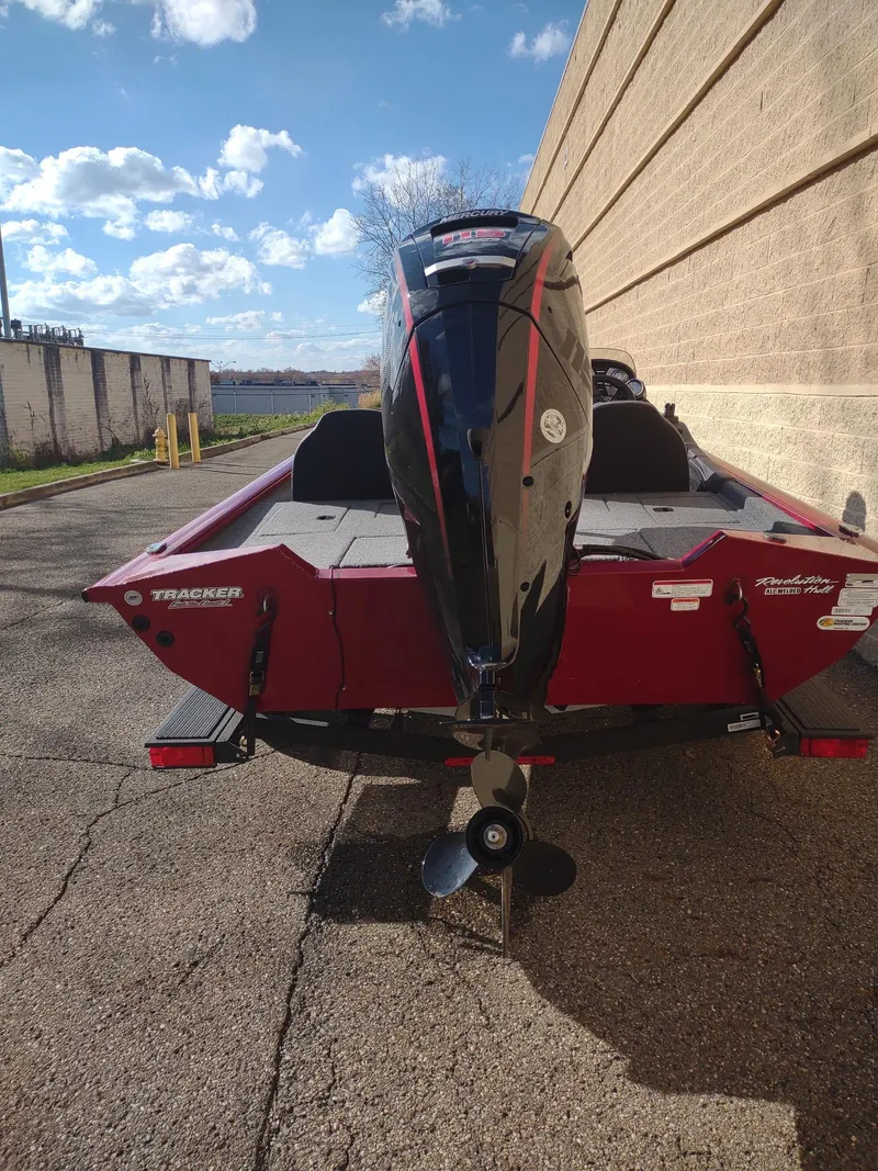 Slide: The Image of 2024 Tracker Pro Team 190 TX boat, rear view, parked outdoors. - 2