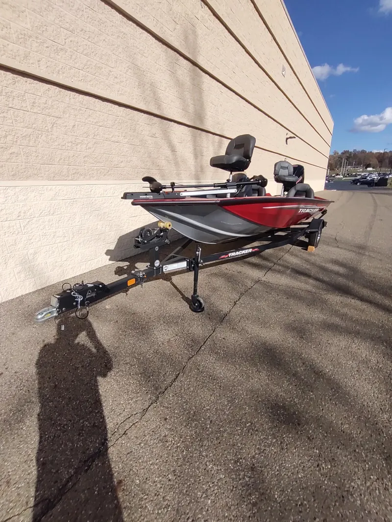 Slide: The Image of 2024 Tracker Pro Team 190 TX fishing boat on trailer, parked outdoors. - 3