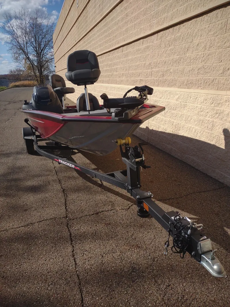 Slide: The Image of 2024 Tracker Pro Team 190 TX boat on trailer, parked outdoors. - 5