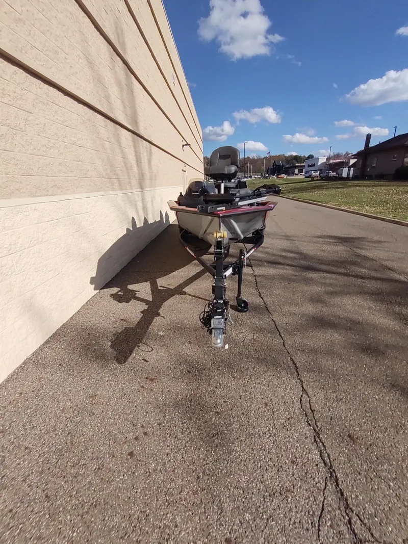 Slide: The Image of 2024 Tracker Pro Team 190 TX boat on pavement, sunny day, blue sky. - 6
