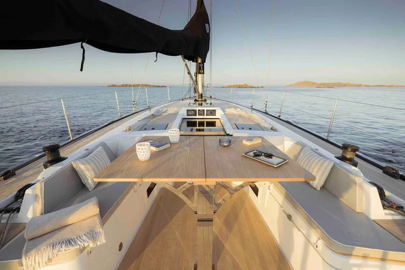 Slide: The Image of Luxurious 2025 Solaris 40 yacht deck with elegant seating and table, set against a serene ocean backdrop. - 4