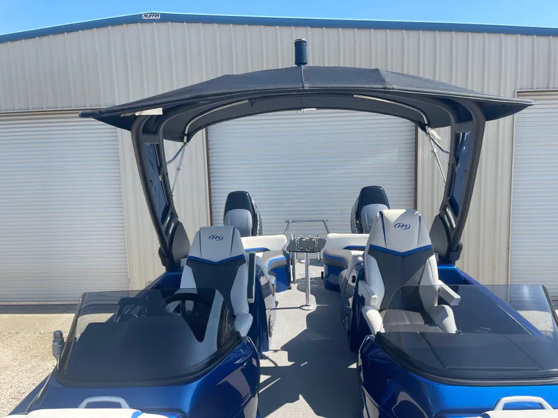 Slide: The Image of 2024 Manitou 25 XT SHP DE pontoon boat with canopy and seating. - 8