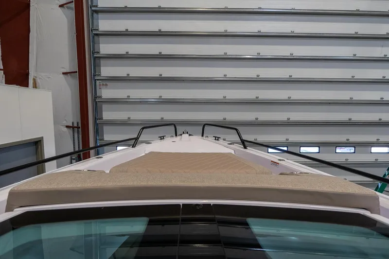 Slide: The Image of Axopar 37 Cross Cabin XC 2024 front deck view in a storage facility. - 12