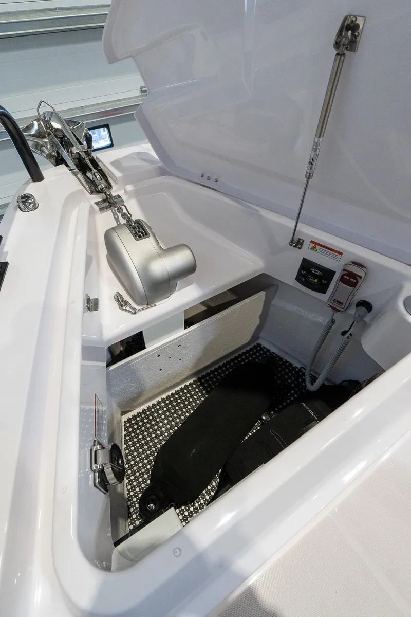 Slide: The Image of 2024 Axopar 37 Cross Cabin XC storage compartment with hydraulic lift and safety equipment. - 14