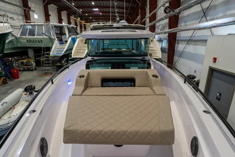 Slide: The Image of 2024 Axopar 37 Cross Cabin XC in a boat storage facility. - 16