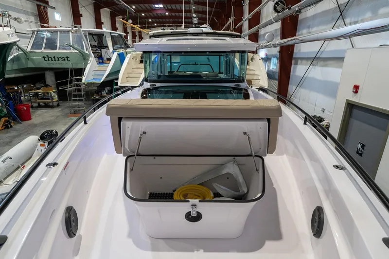 Slide: The Image of 2024 Axopar 37 Cross Cabin XC boat interior with open storage compartment. - 17