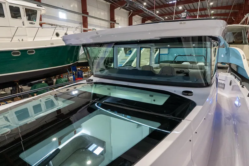 Slide: The Image of 2024 Axopar 37 Cross Cabin XC in a boat showroom. - 19