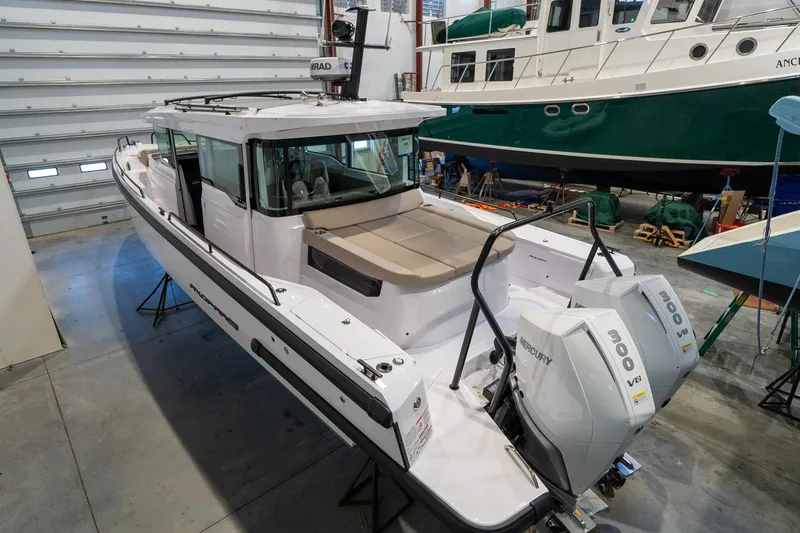 Slide: The Image of 2024 Axopar 37 Cross Cabin XC in a boat storage facility. - 2