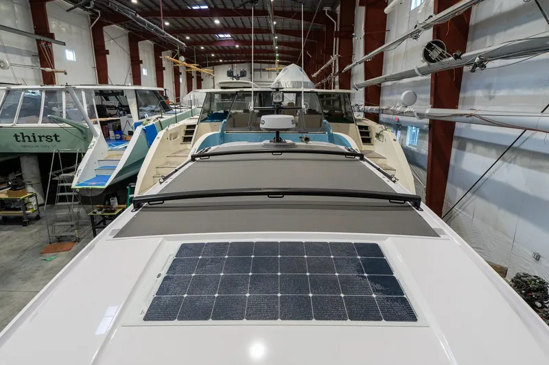 Slide: The Image of 2024 Axopar 37 Cross Cabin XC in a boat storage facility. - 20