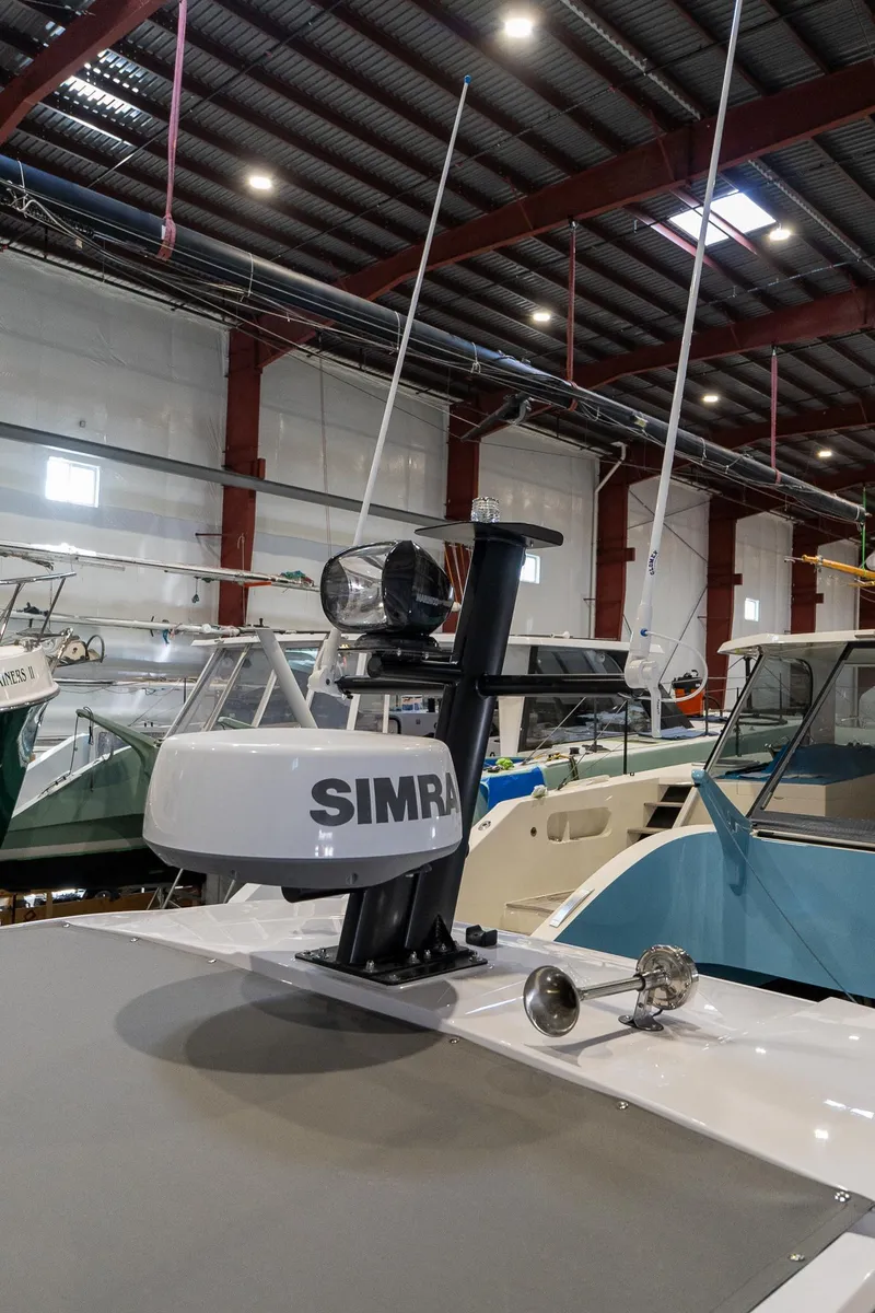 Slide: The Image of 2024 Axopar 37 Cross Cabin XC in a boat storage facility. - 21