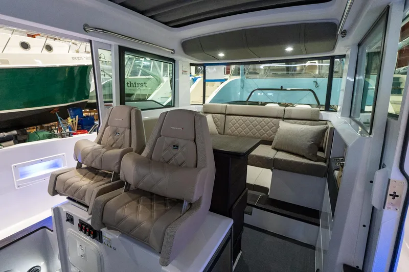 Slide: The Image of Interior of 2024 Axopar 37 Cross Cabin XC with plush seating and modern design. - 22