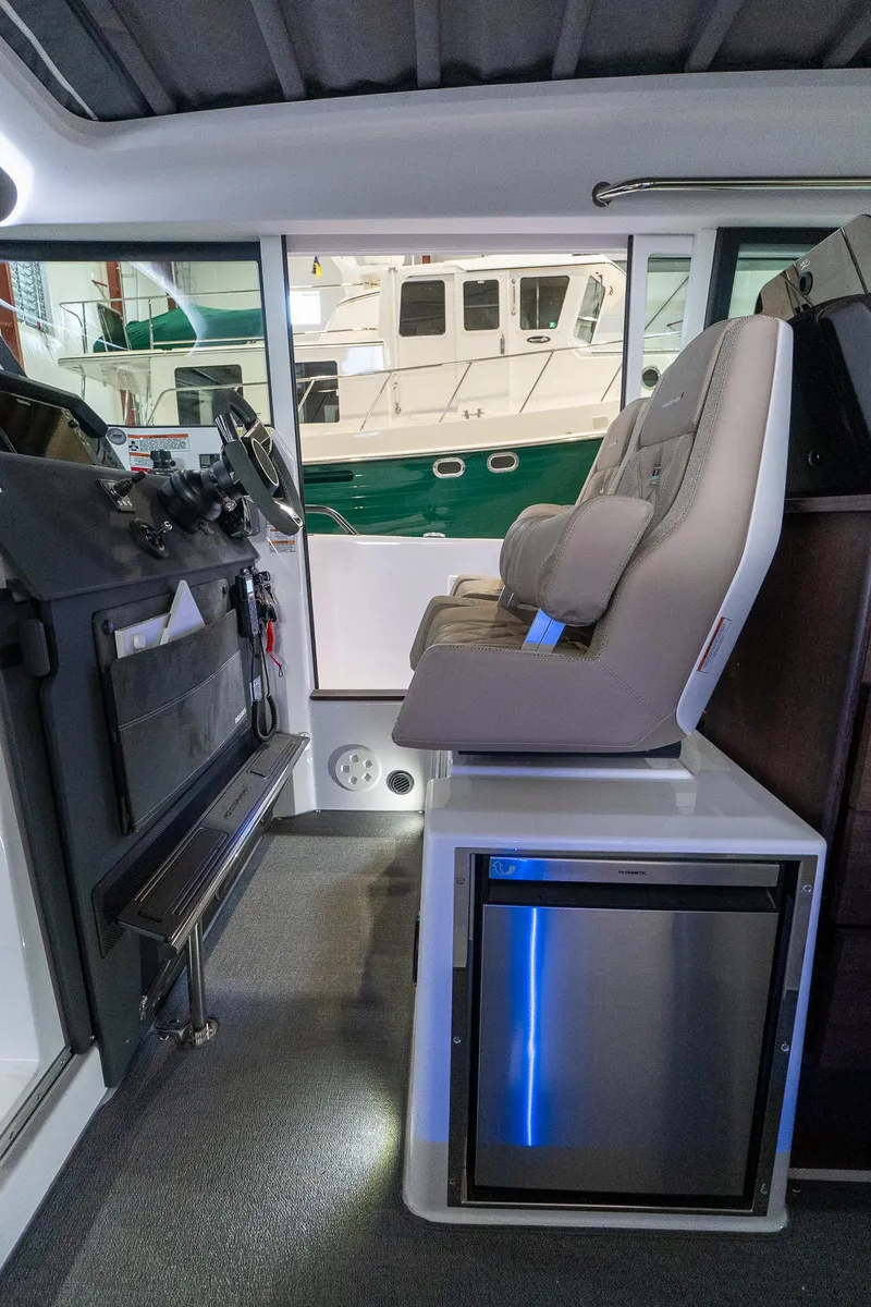 Slide: The Image of Interior of 2024 Axopar 37 Cross Cabin XC with seating and mini fridge. - 23