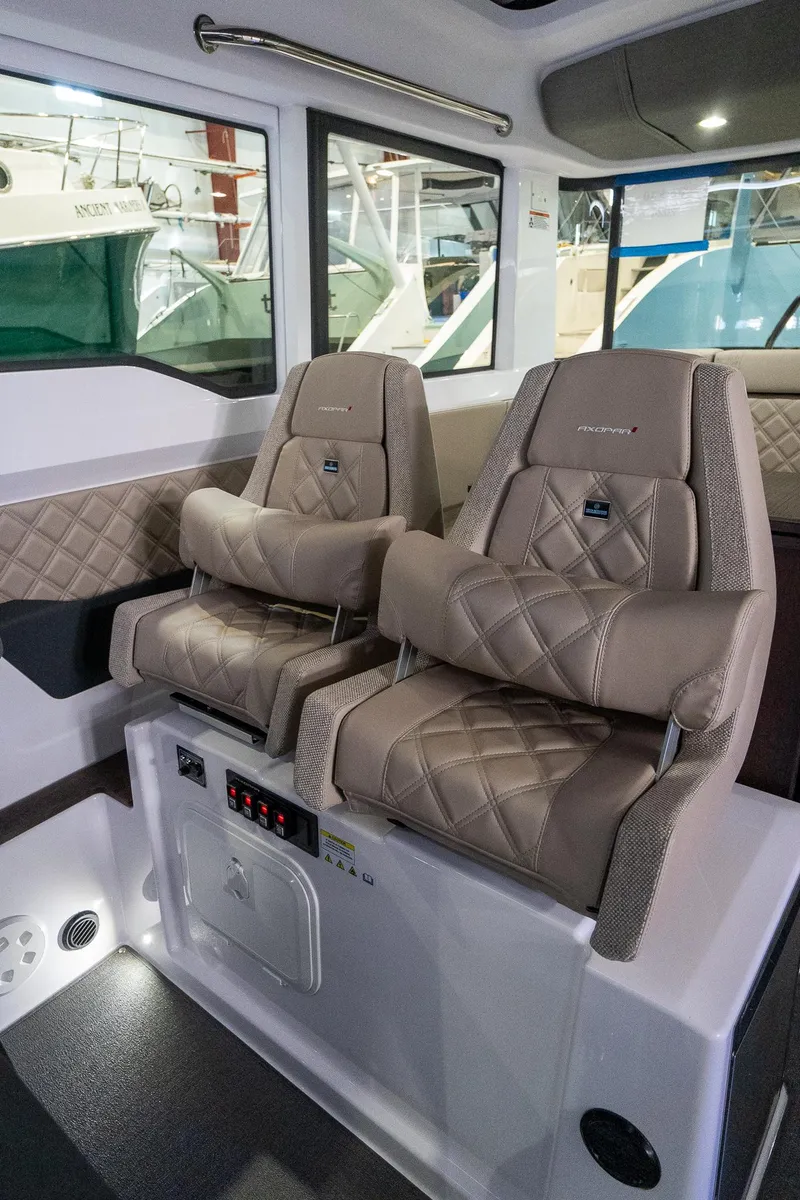 Slide: The Image of 2024 Axopar 37 Cross Cabin XC interior seating with luxurious, diamond-stitched upholstery. - 26