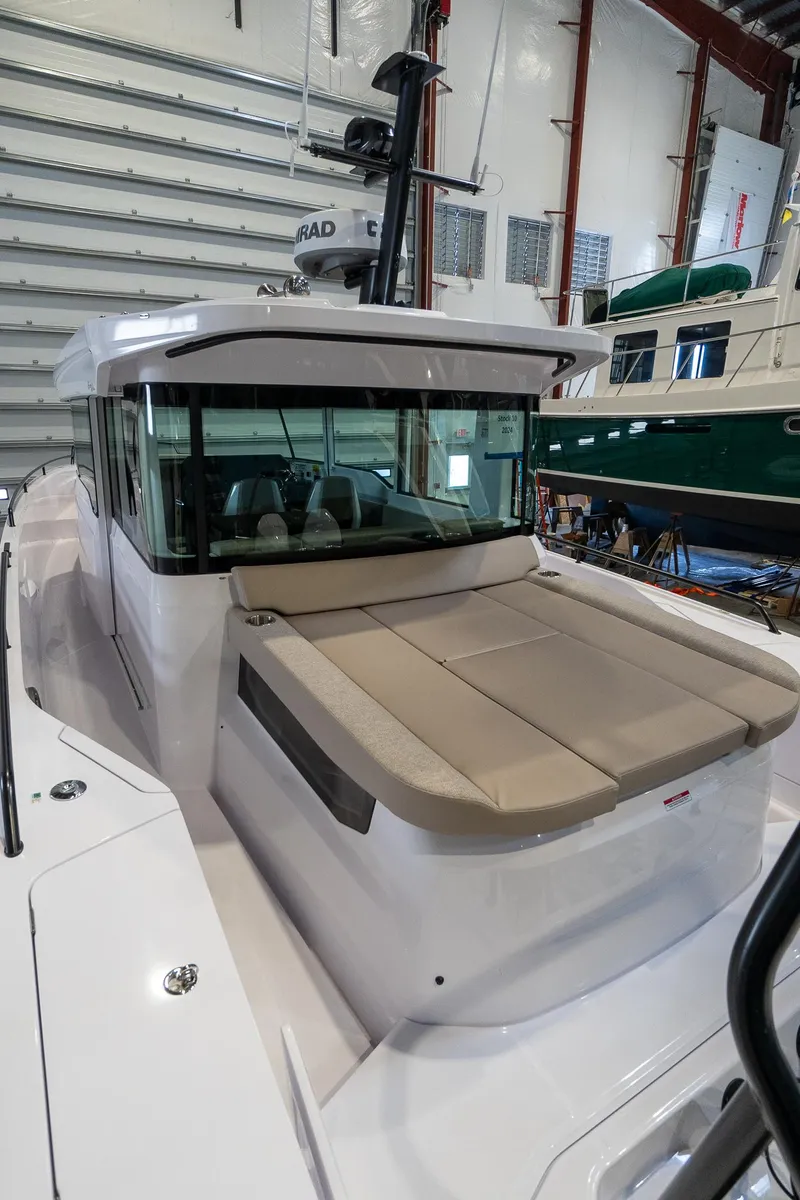 Slide: The Image of 2024 Axopar 37 Cross Cabin XC in a boat showroom. - 3