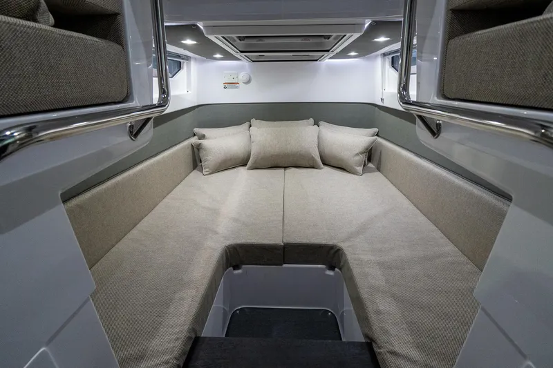 Slide: The Image of 2024 Axopar 37 Cross Cabin XC interior cabin with cozy seating and cushions. - 30