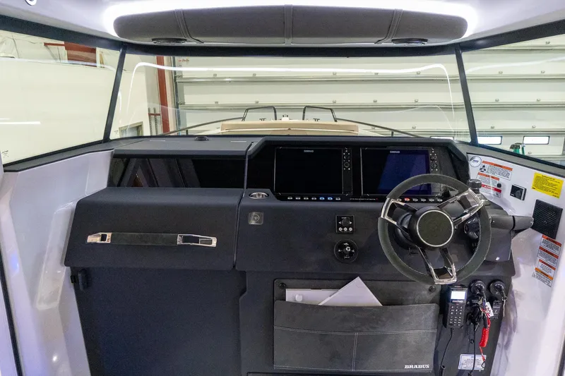 Slide: The Image of Axopar 37 Cross Cabin XC 2024 helm station with modern controls and navigation equipment. - 32